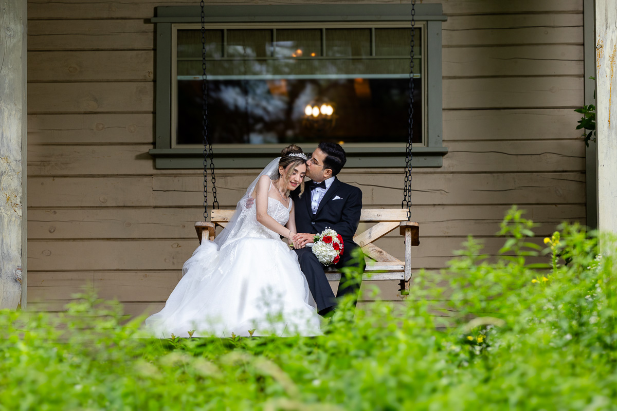 Sahar and Maziar embrace on a swing at Le Belvedere on their wedding day
