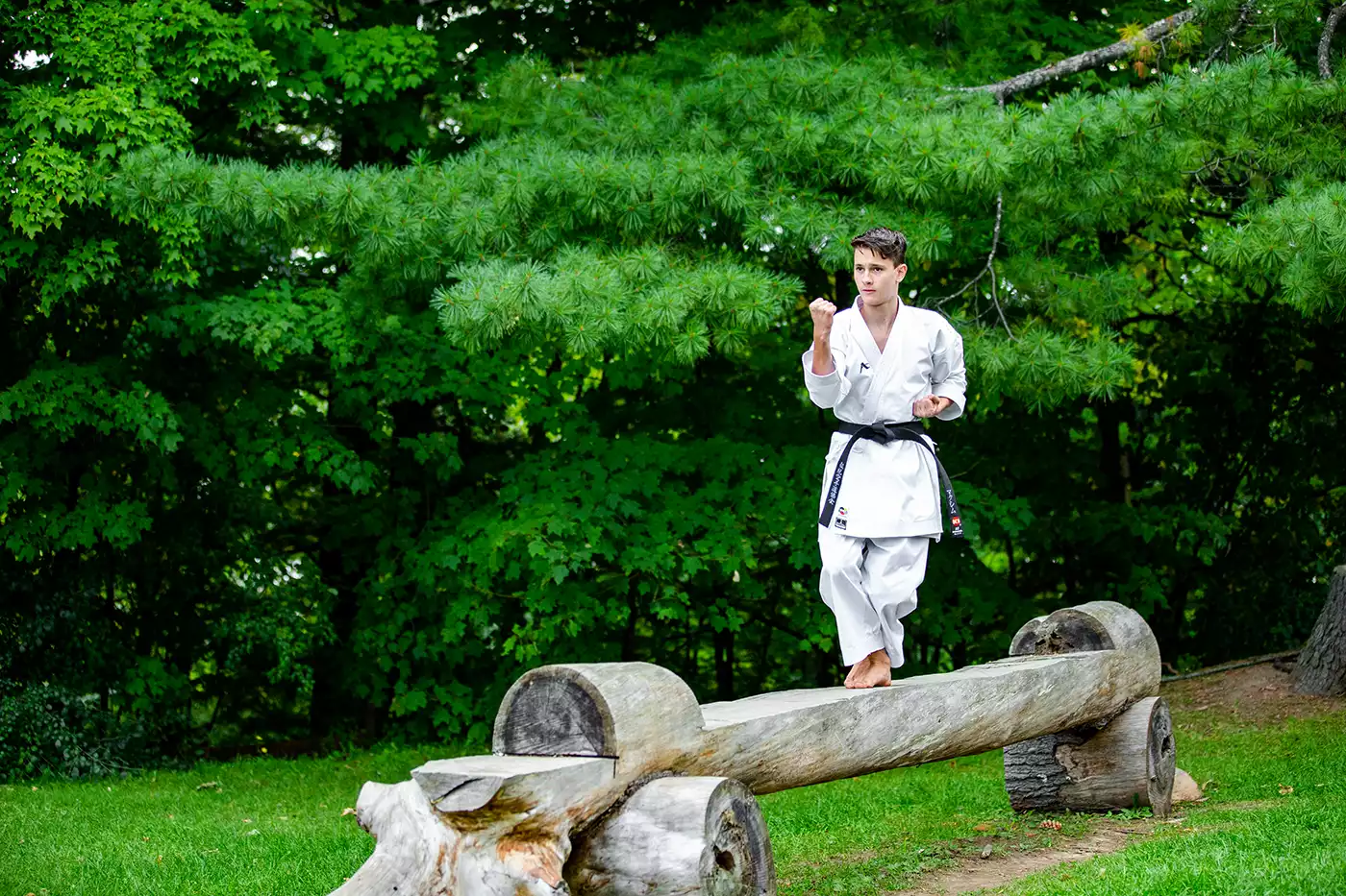 KTK Martial Arts student performing a kata while balancing on a log.  Sport photography by Jeffrey Meyer