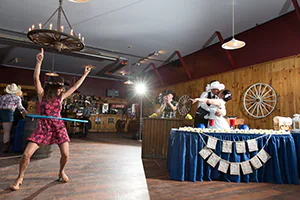 A lady performs an awesome hula-hoop dance to keep the bride and groom kissing for a while