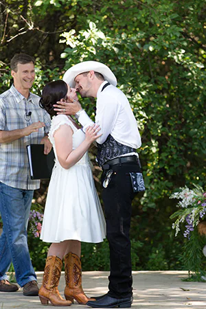 A bride and groom share a first kiss