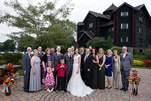 A bride and groom take a family portrait with their new in-laws